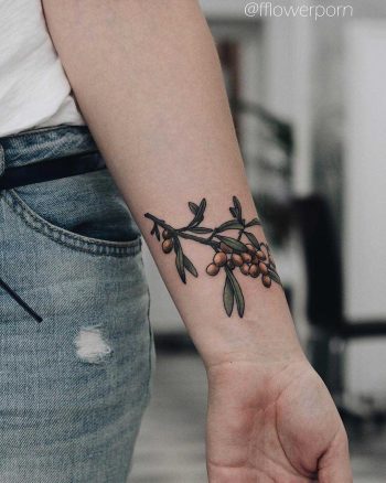 Sea buckthorn tattoo on the left wrist