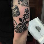 Skeleton hand and rose tattoo
