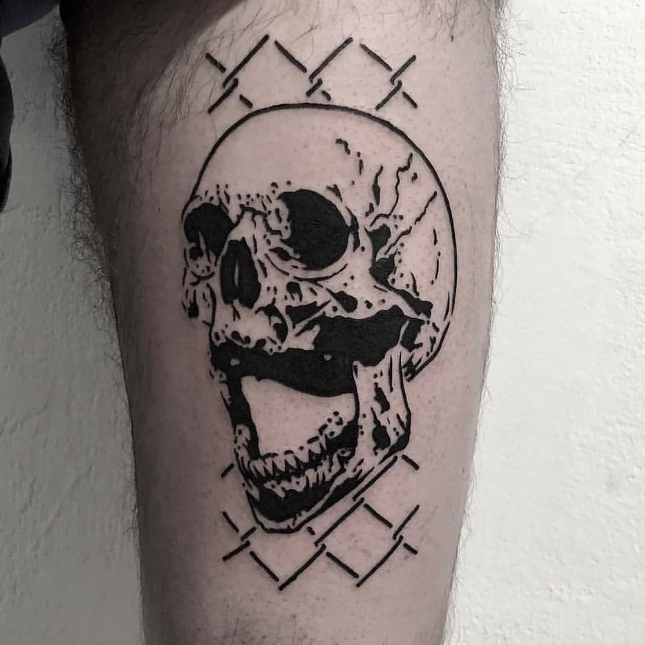 Skull and fence tattoo
