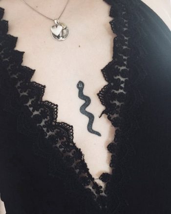 Small snake tattoo on the sternum