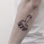 Stamp tattoo on the forearm