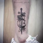 Sword and crescent moon tattoo