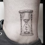 Tiny hourglass tattoo by Pablo Torre