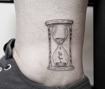 Tiny hourglass tattoo by Pablo Torre