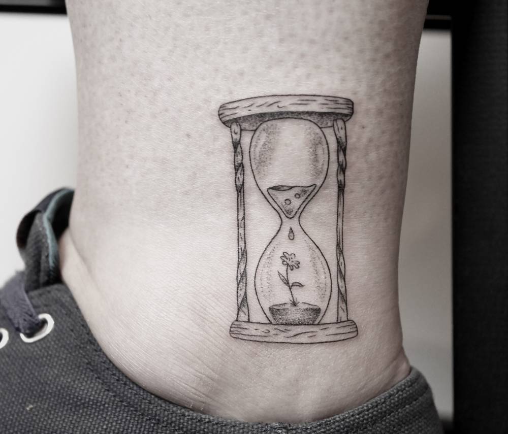 Tiny hourglass tattoo by Pablo Torre 