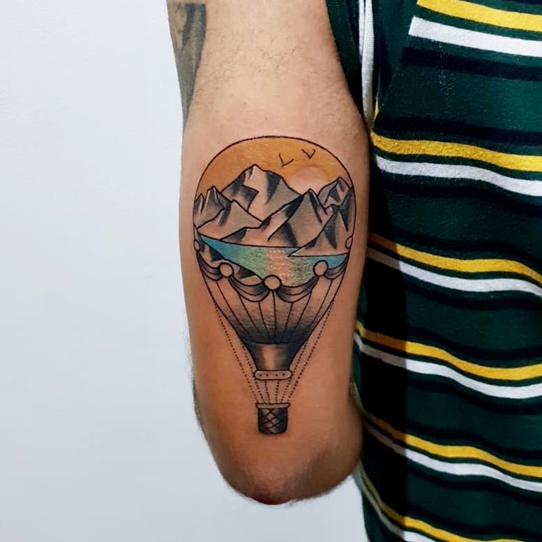 Traditional style hot air balloon and landscape tattoo