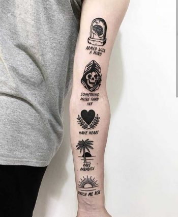 Various black tattoos on the left arm