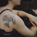 Wave tattoo on the back by Yi Postyism