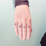 AMOR tattoo on the fingers