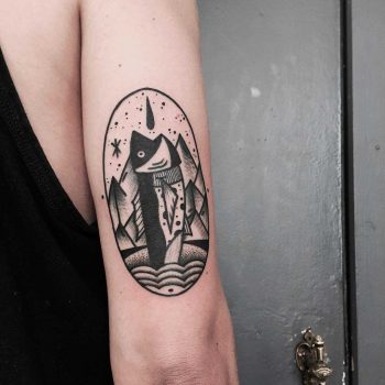 Abstract fish tattoo on the arm