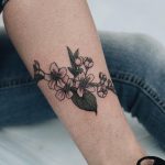 Apple blossoms tattoo on the shin
