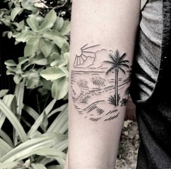 Beach scene tattoo on the forearm