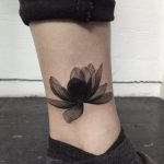 Black Lotus flower tattoo on the ankle