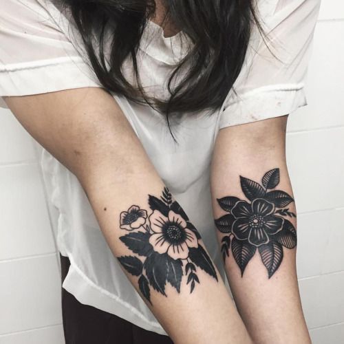 Black and white flowers on forearm