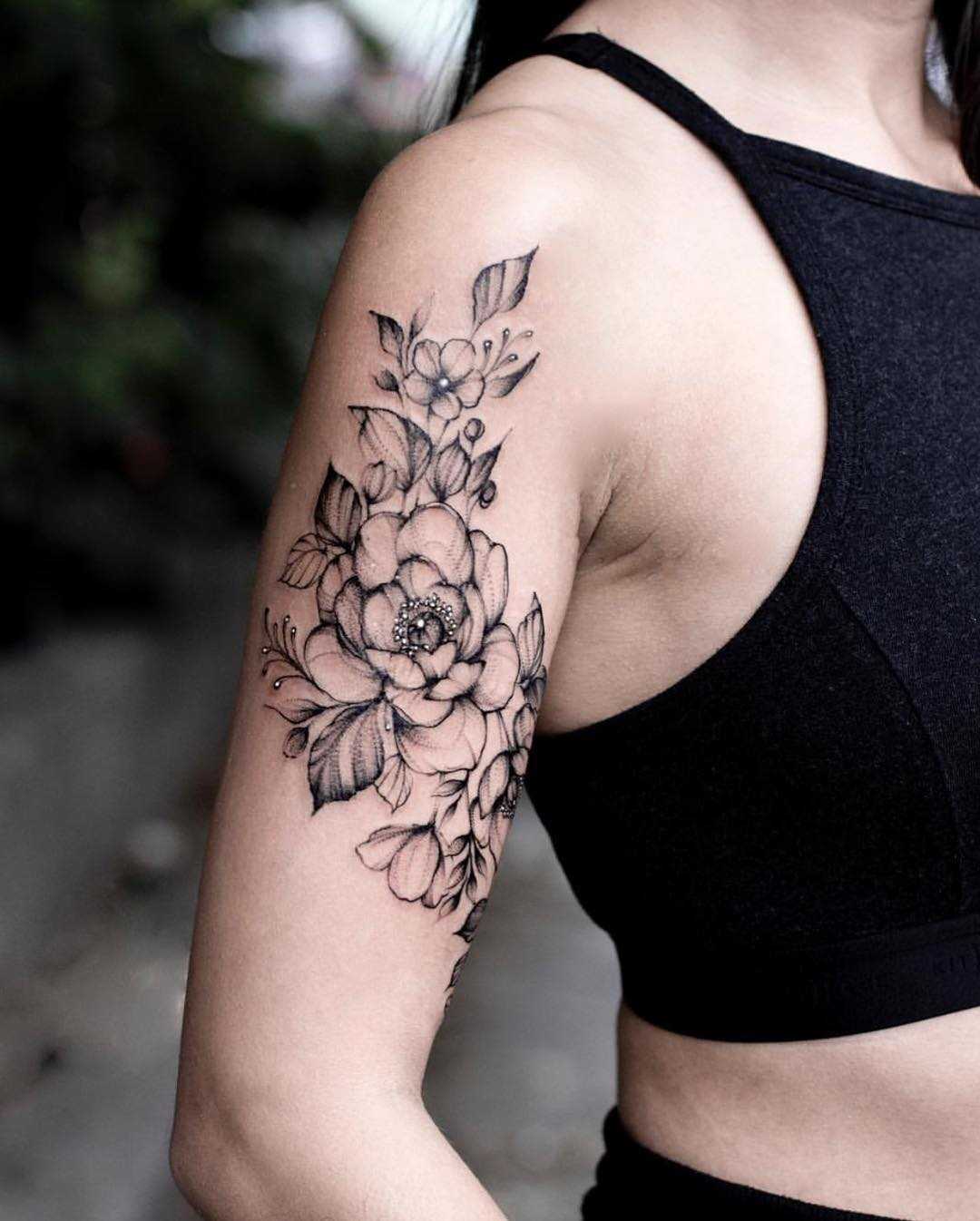 Black floral piece on the right arm - Tattoogrid.net