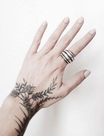 Black greenery inked on the hand