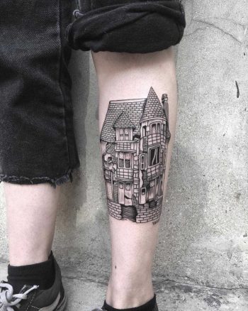 Black house tattoo on the left shin