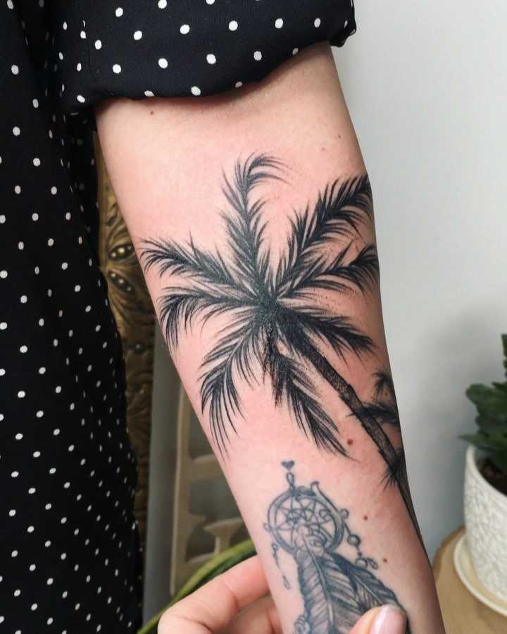 Blackwork palm tree tattoo on the left forearm - Tattoogrid.net