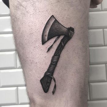 Blackwork style ax tattoo