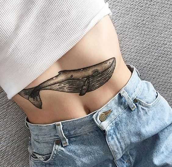 Blackwork whale tattoo on the belly