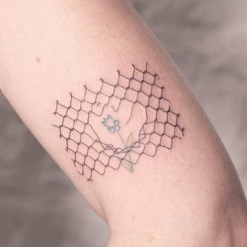 Broken fence and flower tattoo