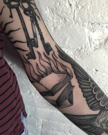Burning books tattoo by Sasha Tattooing
