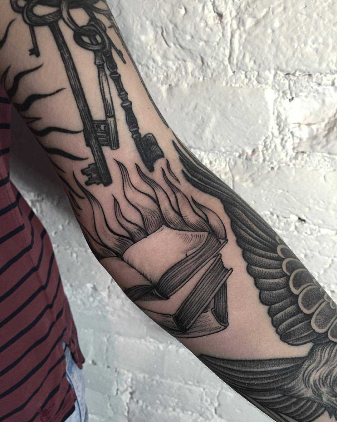 Burning books tattoo by Sasha Tattooing