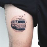 Bus tattoo on the thigh