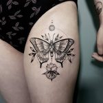 Butterfly and flower tattoo on the thigh