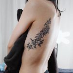 Camellia tattoos on the left rib cage