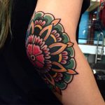 Colorful traditional floral elbow tattoo