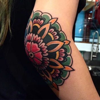 Colorful traditional floral elbow tattoo