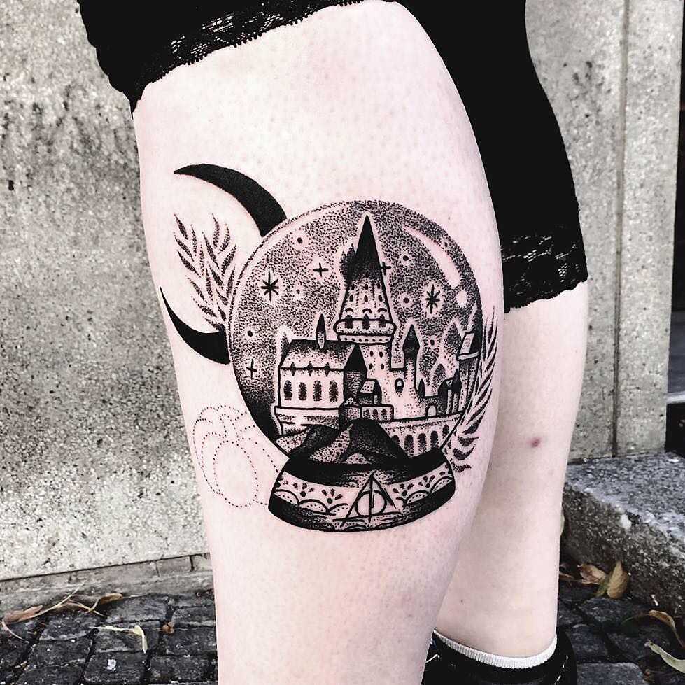 Crystal ball with Hogwarts scenery tattoo