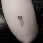 Dot-work tooth tattoo done at Mu Body Arts Studio