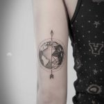 Earth and arrow tattoo