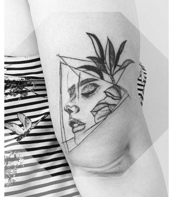 Face within flowers tattoo