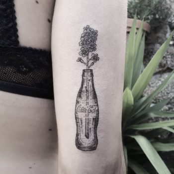 Flowers in a Coca-Cola bottle