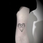 Geometric heart-diamond tattoo