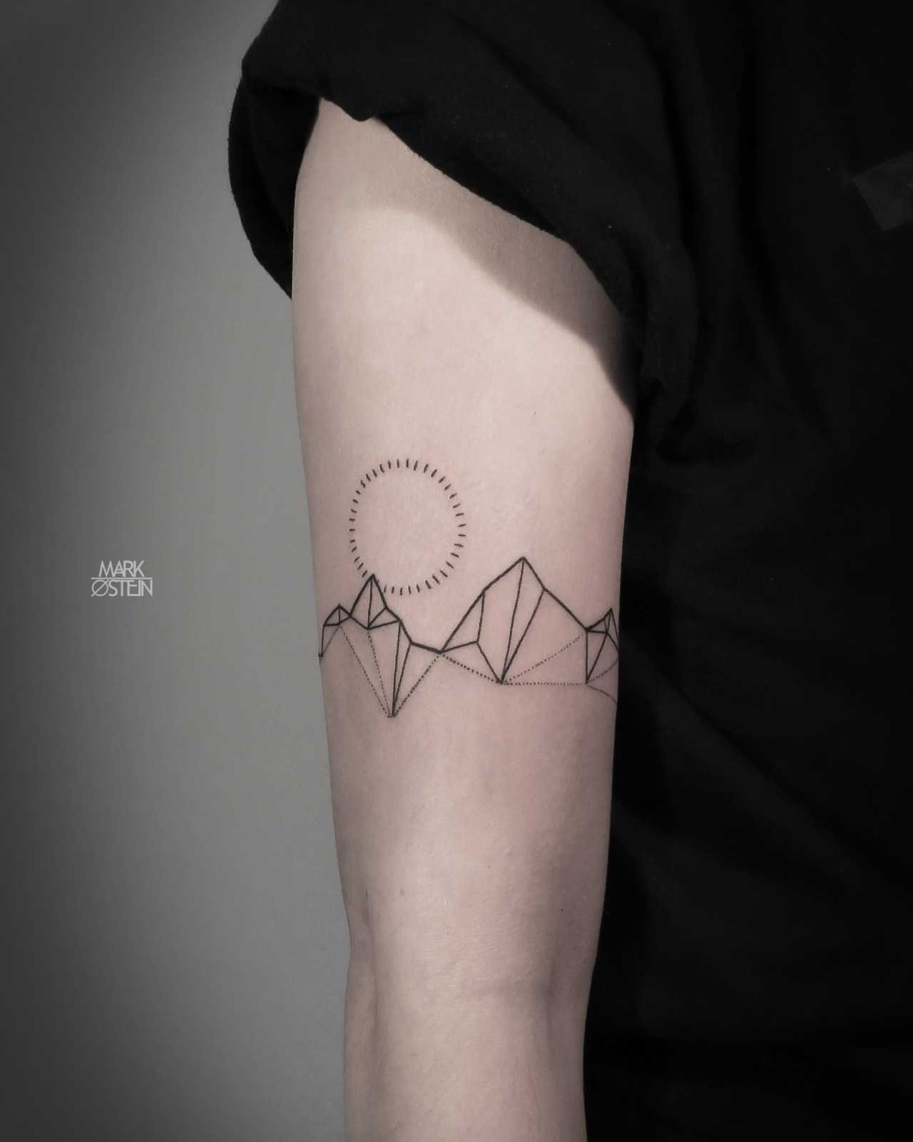 Geometric mountains and dotted sun tattoo