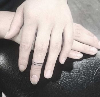 Hand-poked finger bands tattoo by Lindsay April