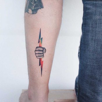 Hand with a lightning bolt tattoo