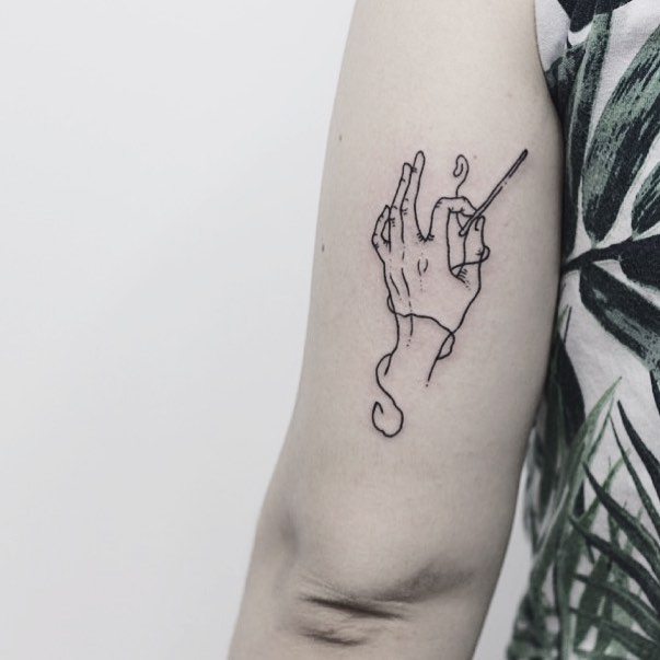 Hand with a needle tattoo