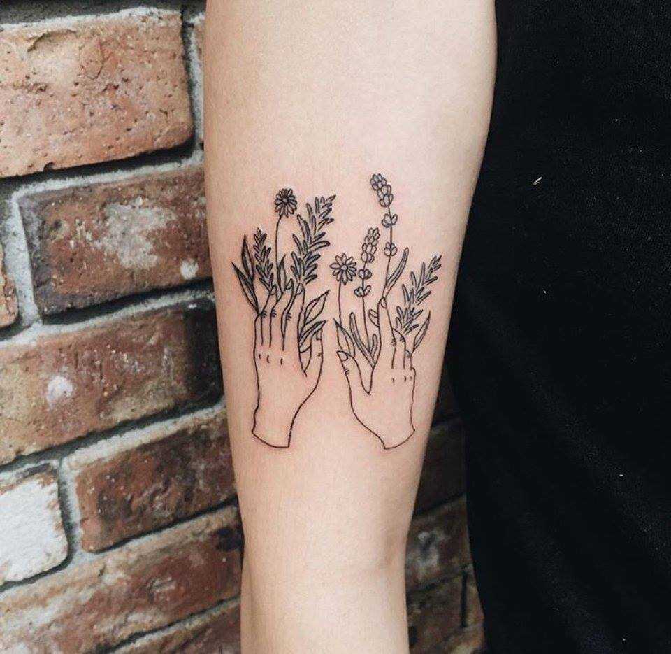 Hands with flowers tattoo