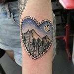 Heart-shaped city scenery tattoo