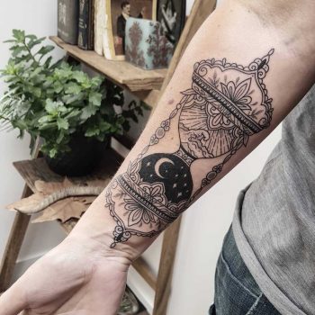 Hourglass tattoo with landscapes