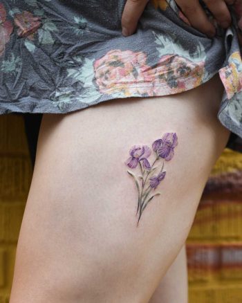Iris flowers tattoo on the thigh