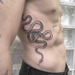 Large snake tattoo on the side