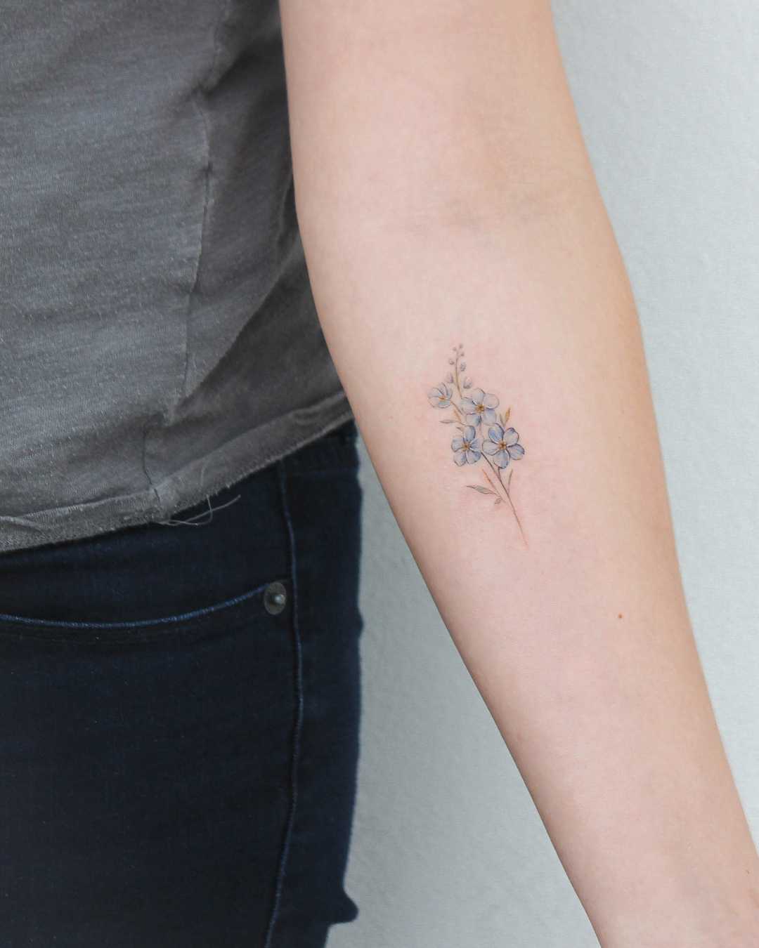 Little Forget-me-not tattoo on the forearm
