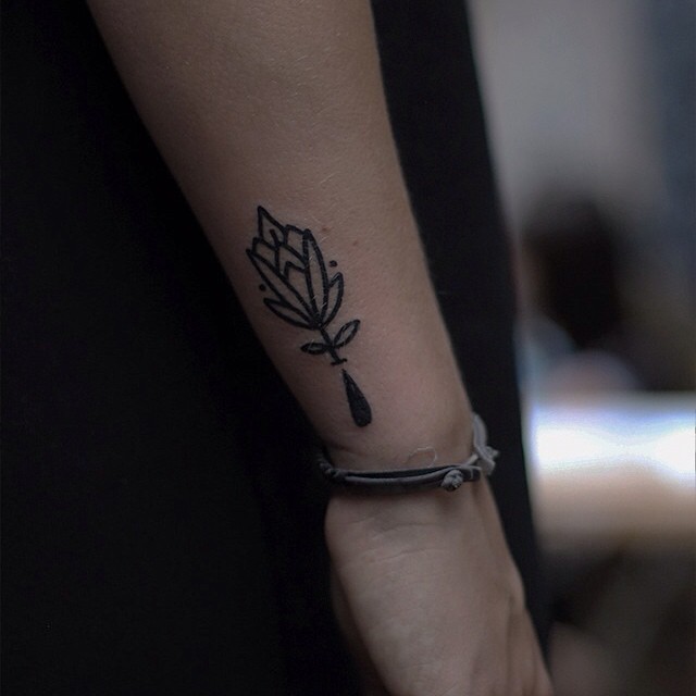 Little black outline flower tattoo