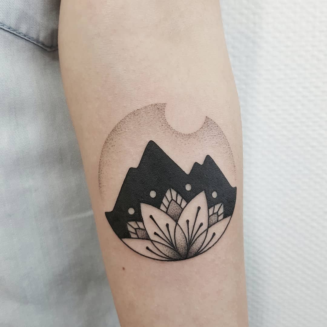 Lotus flower and mountains tattoo